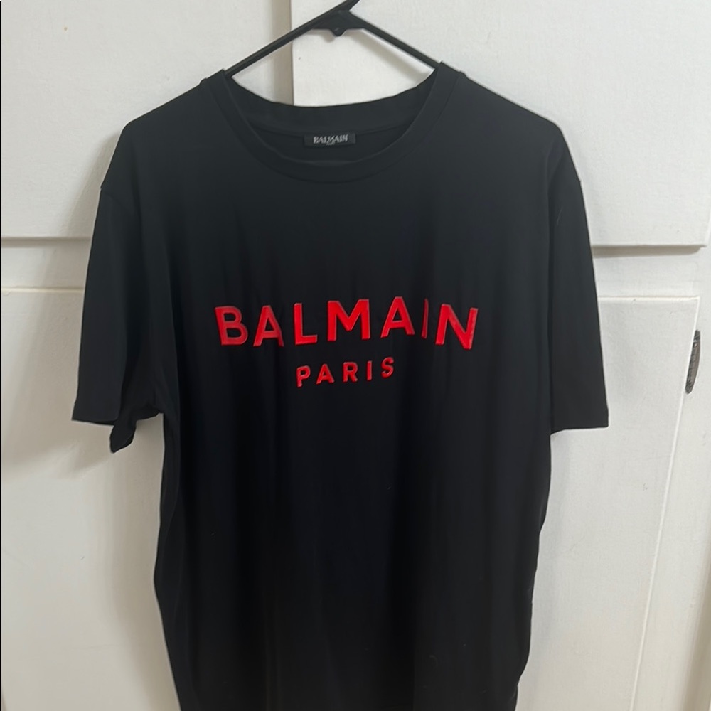 Balmain, Paris men’s T-shirt in the black with red logo. Size extra large.